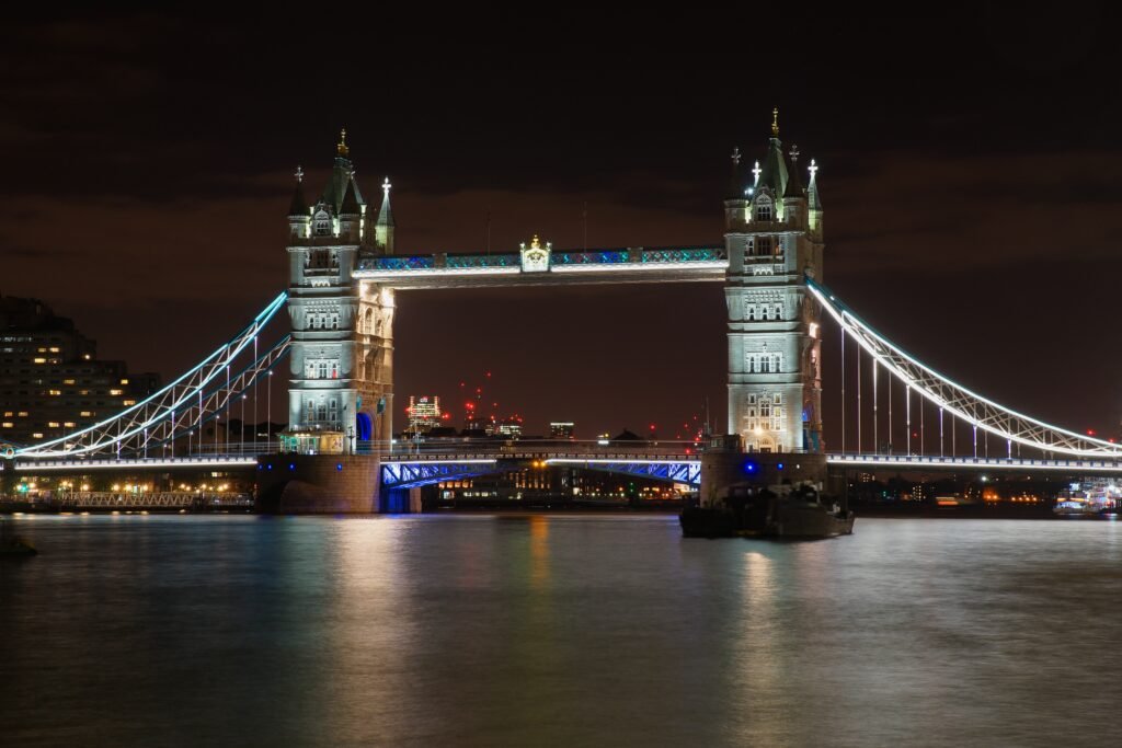 Low angle shot of the famous Tower Bridge in London illuminated with night lights